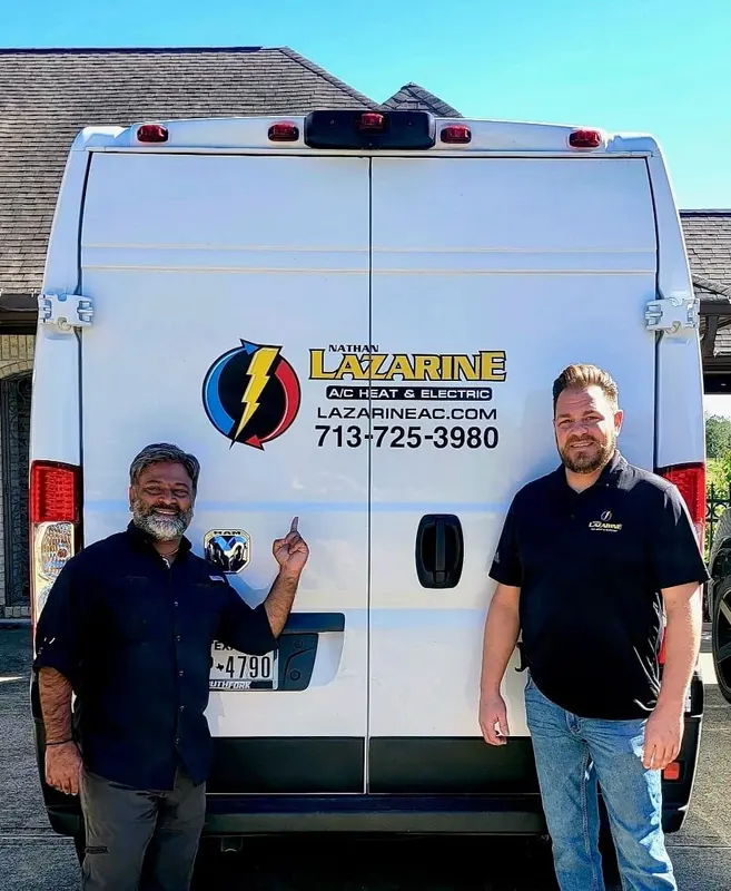 Two Lazarine AC crew members standing at the back of the branded service van